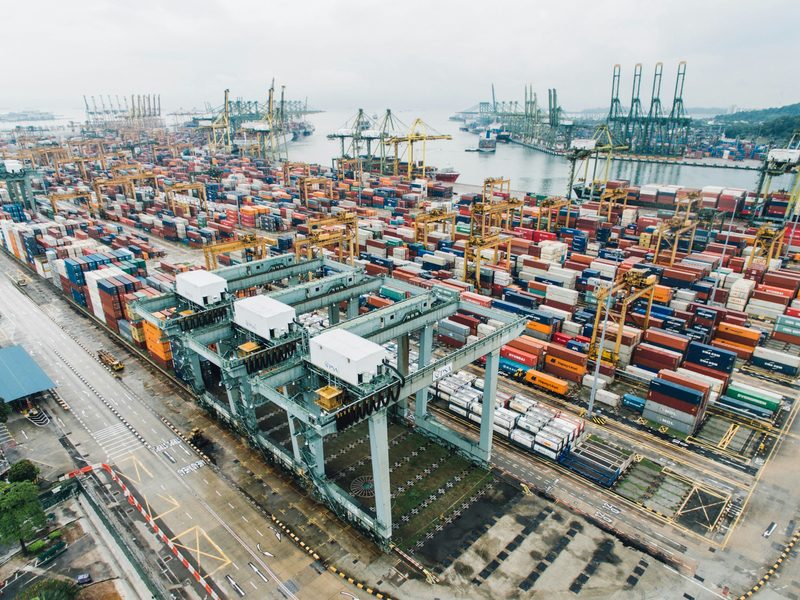 An aerial view of a container terminal stacked with shipping containers