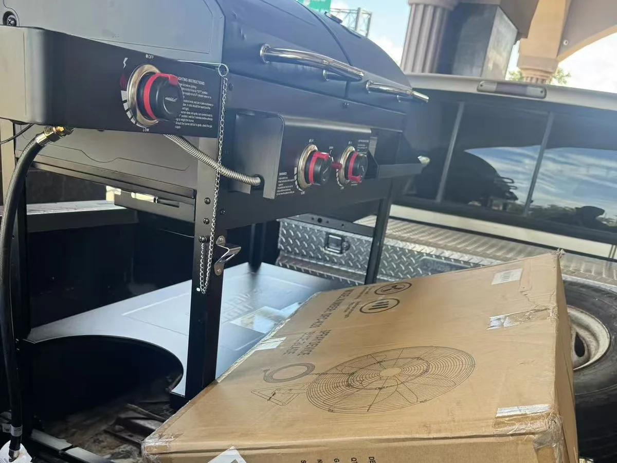 A flat-top griddle and a boxed unit in a pickup bed at the Cube-Age Houston sale