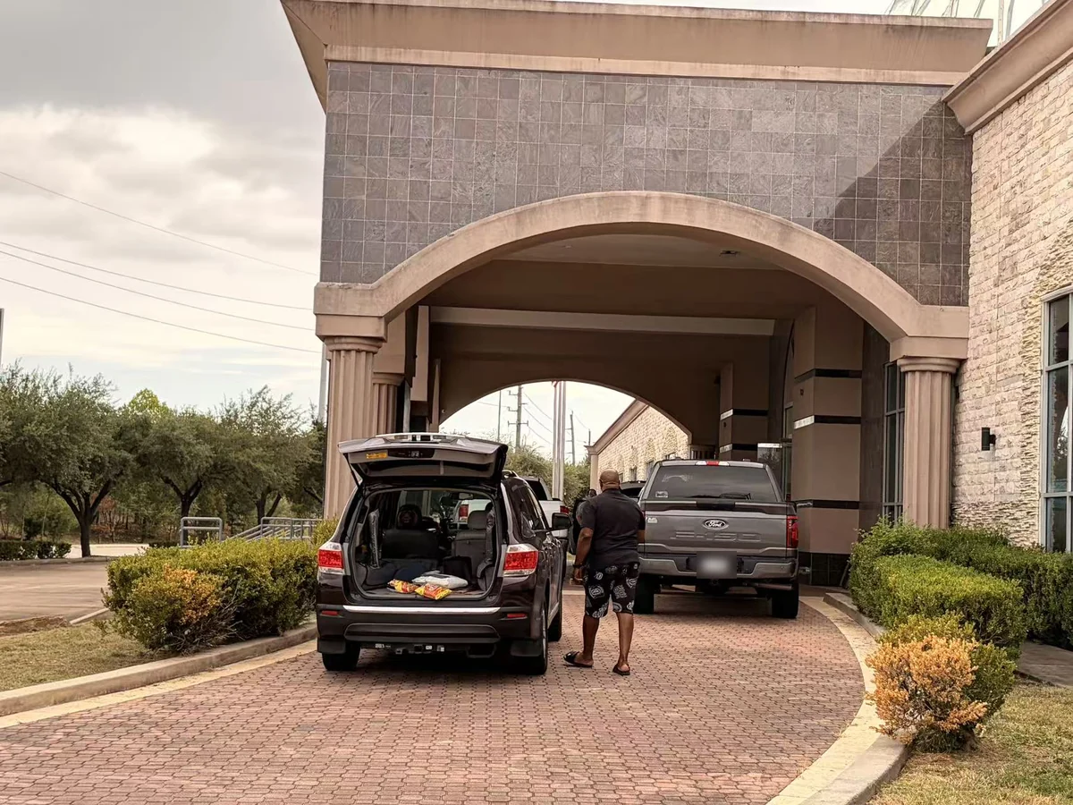 Vehicles loading under the entrance arch of the Cube-Age Houston sale on day three
