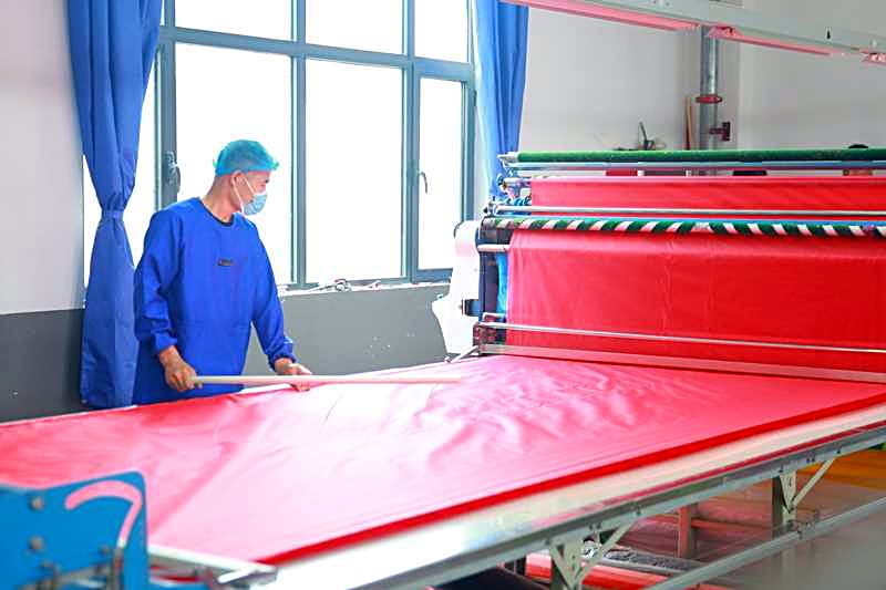 Printed kite fabric spread and aligned on the cutting table