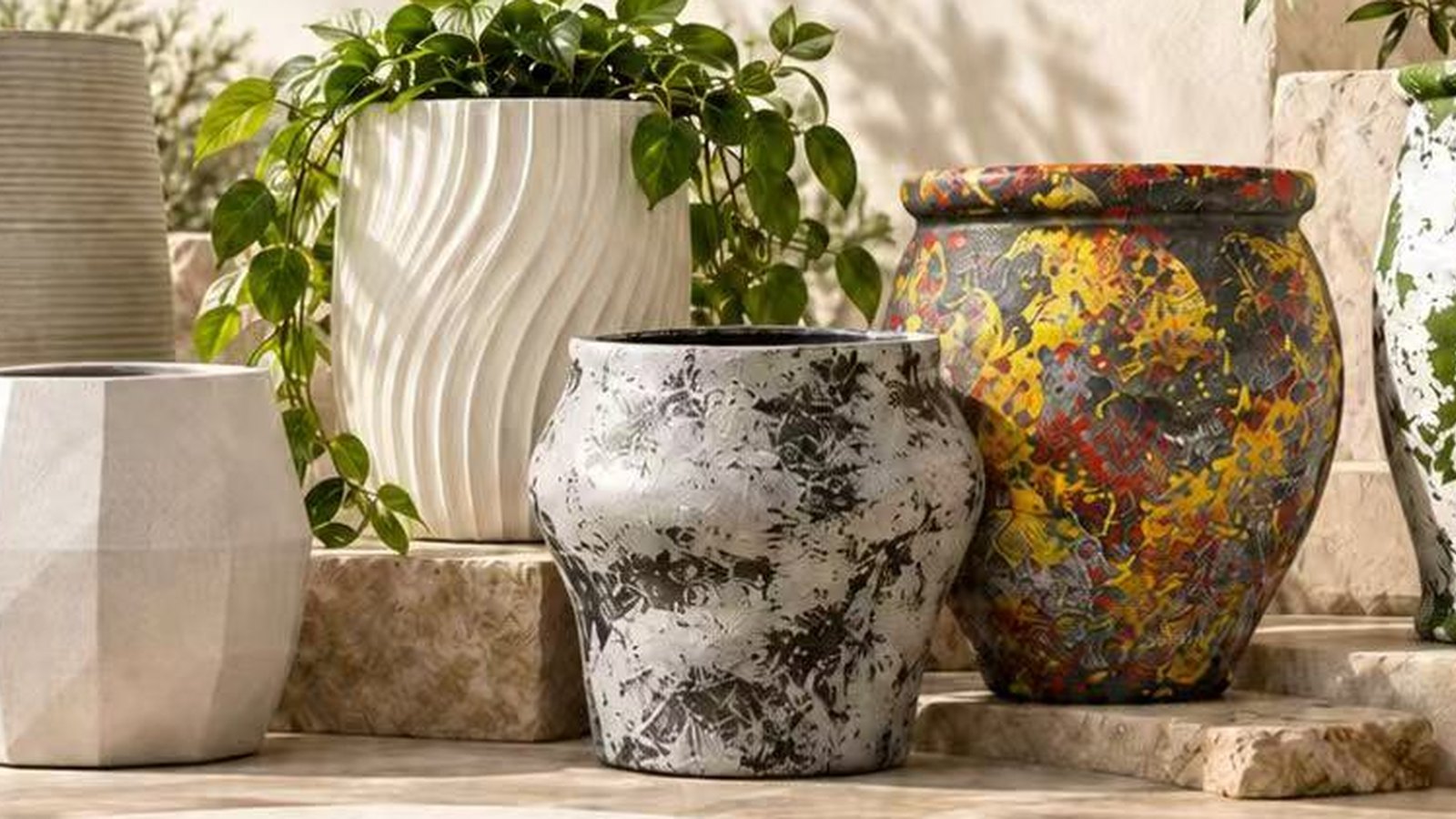 A group of magnesium oxide planters on a stone terrace