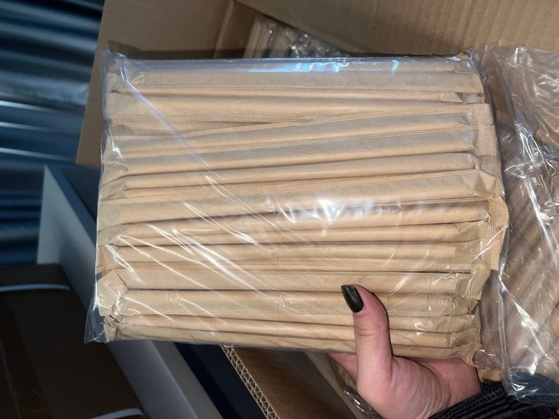 A sealed bag of paper-wrapped bamboo drinking straws