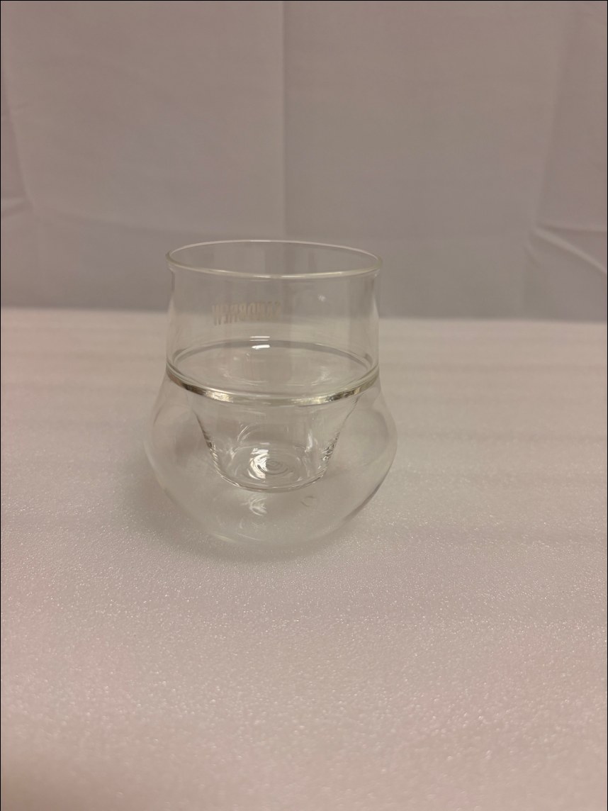 A small double-wall glass cup with a flared tulip shape
