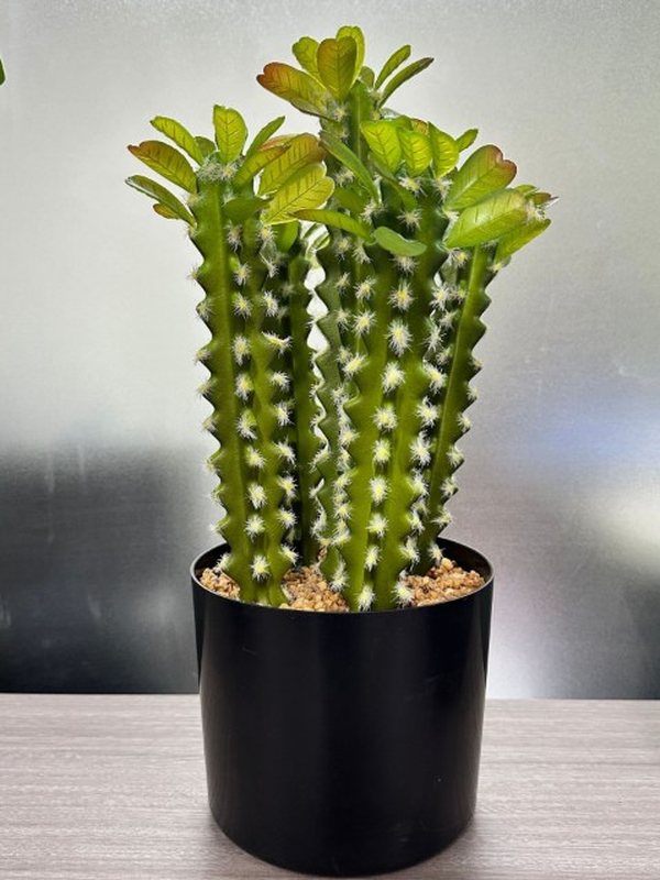 A potted artificial cactus with a flowering top