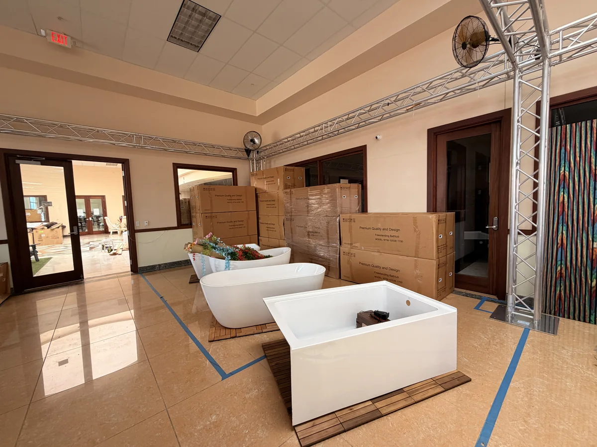 Freestanding bathtubs being set out in the Cube-Age showroom