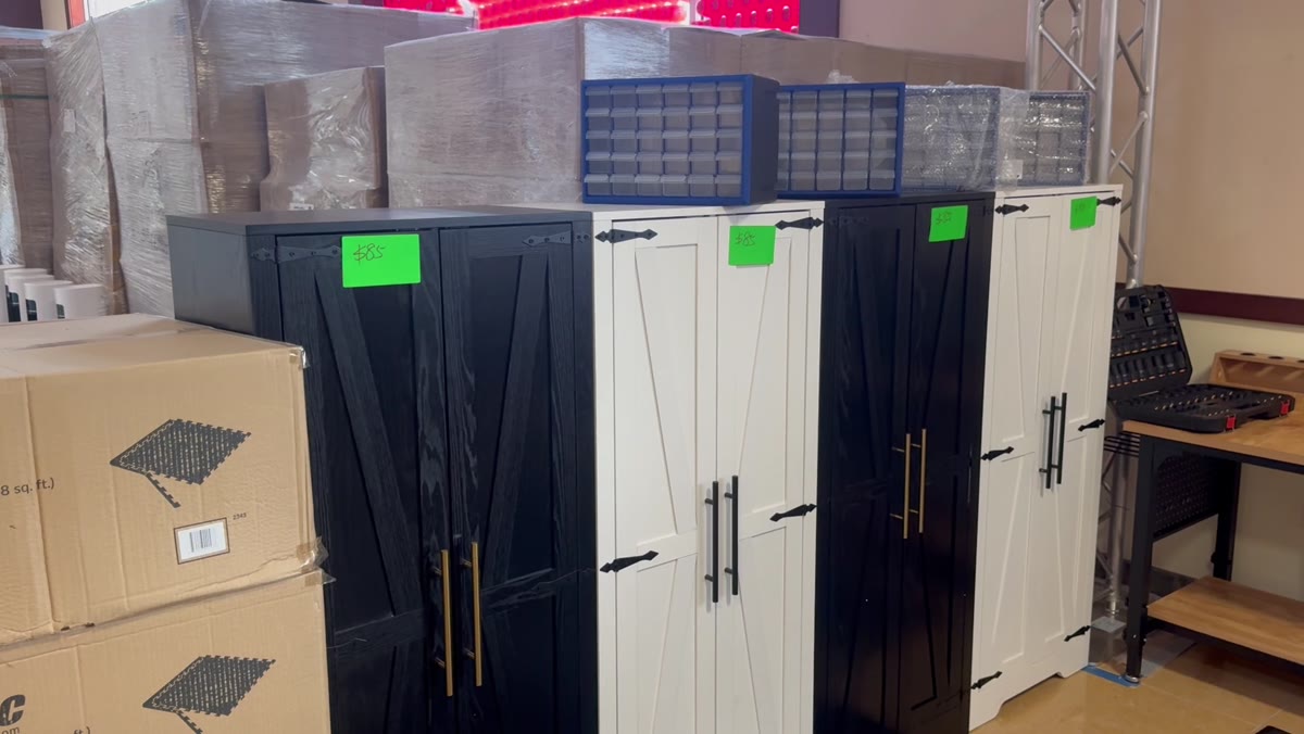 Black and white storage cabinets next to workbenches