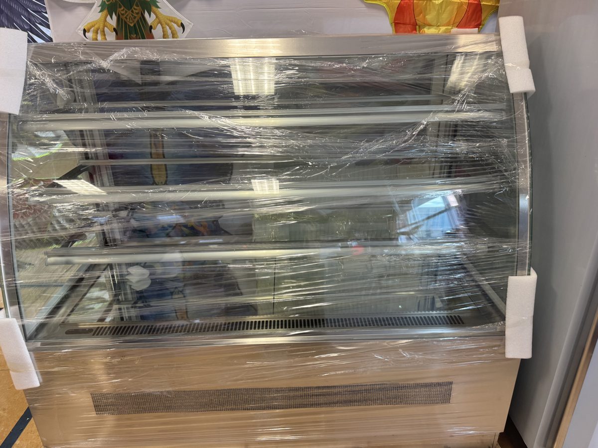 Curved-glass cake display case, still wrapped